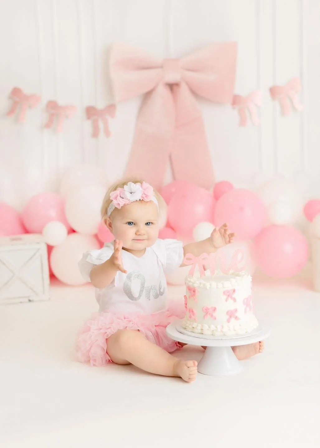 One-year-old with a styled cake at a Syracuse cake smash session