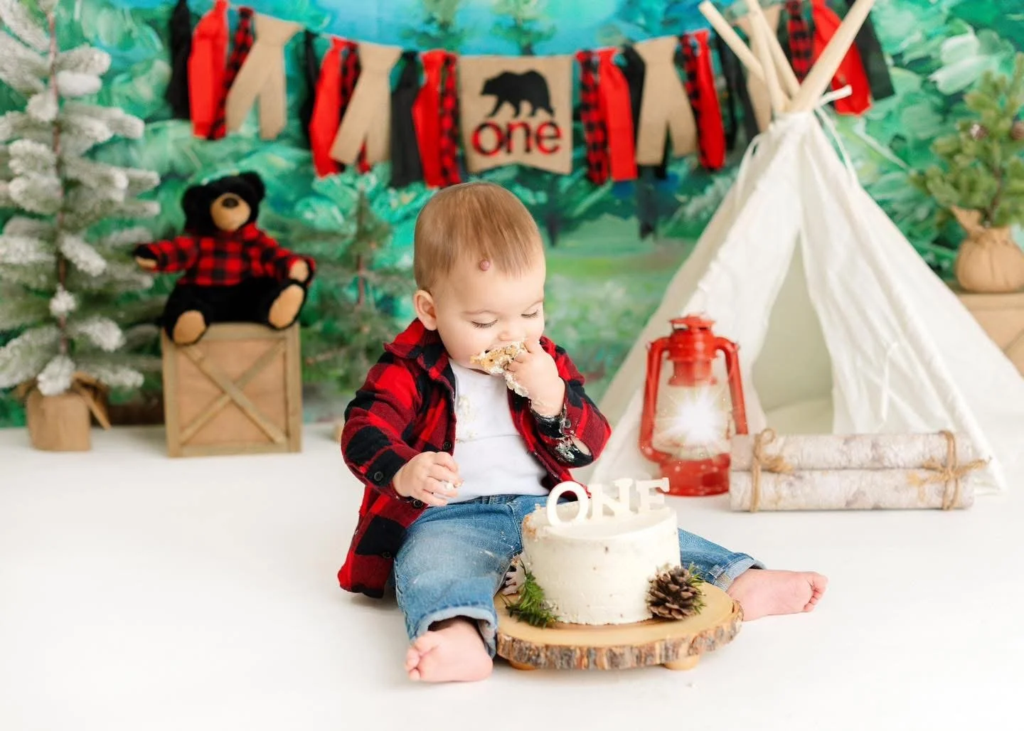 Baby exploring their first birthday cake in-studio