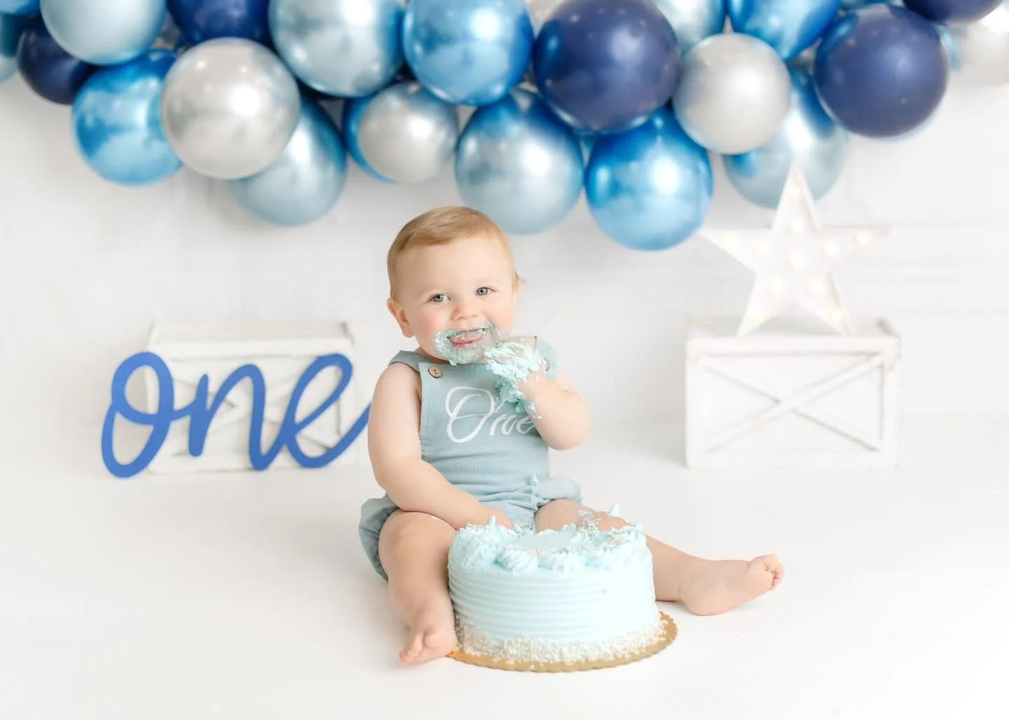 One-year-old with a styled cake at a Syracuse cake smash session