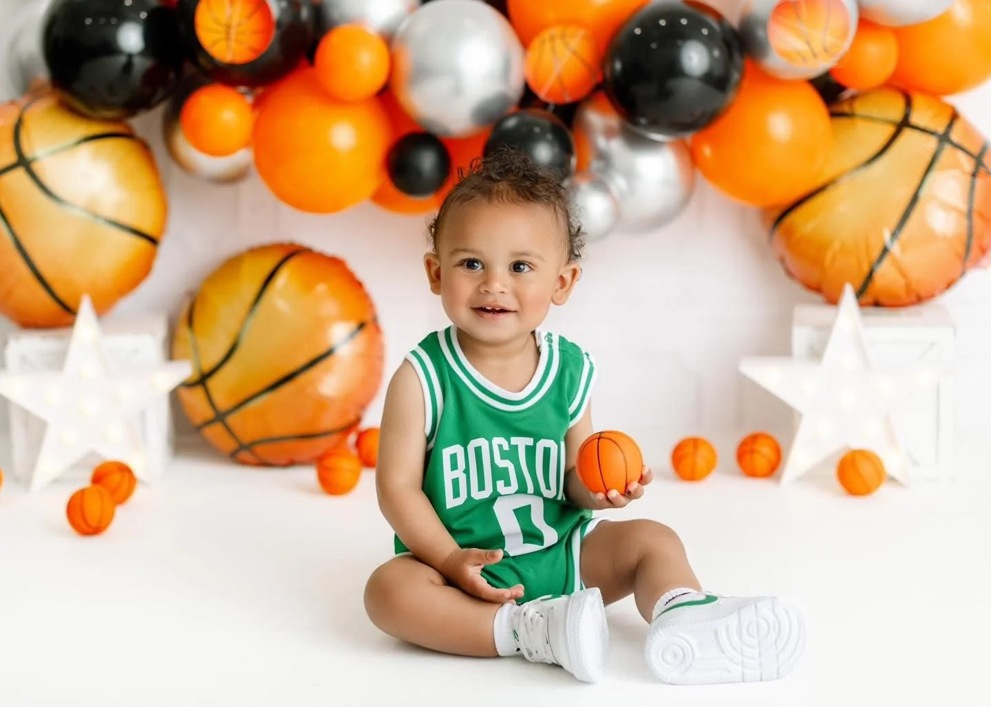 Baby exploring their first birthday cake in-studio