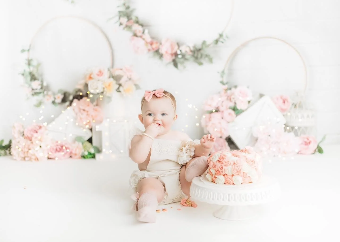 Baby exploring their first birthday cake in-studio