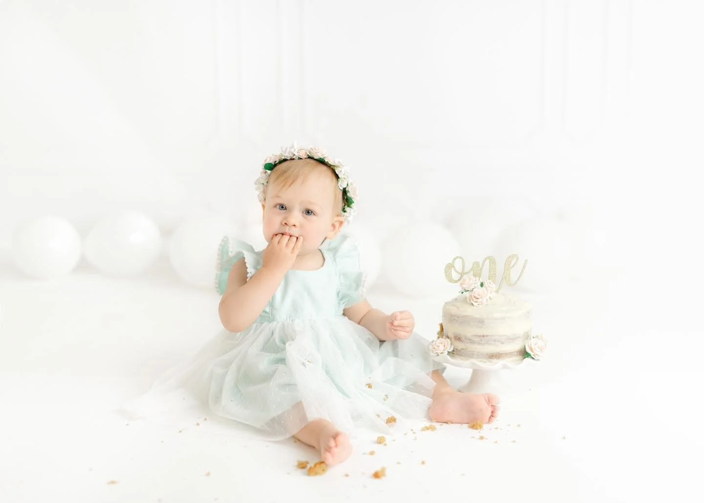One-year-old with a styled cake at a Syracuse cake smash session