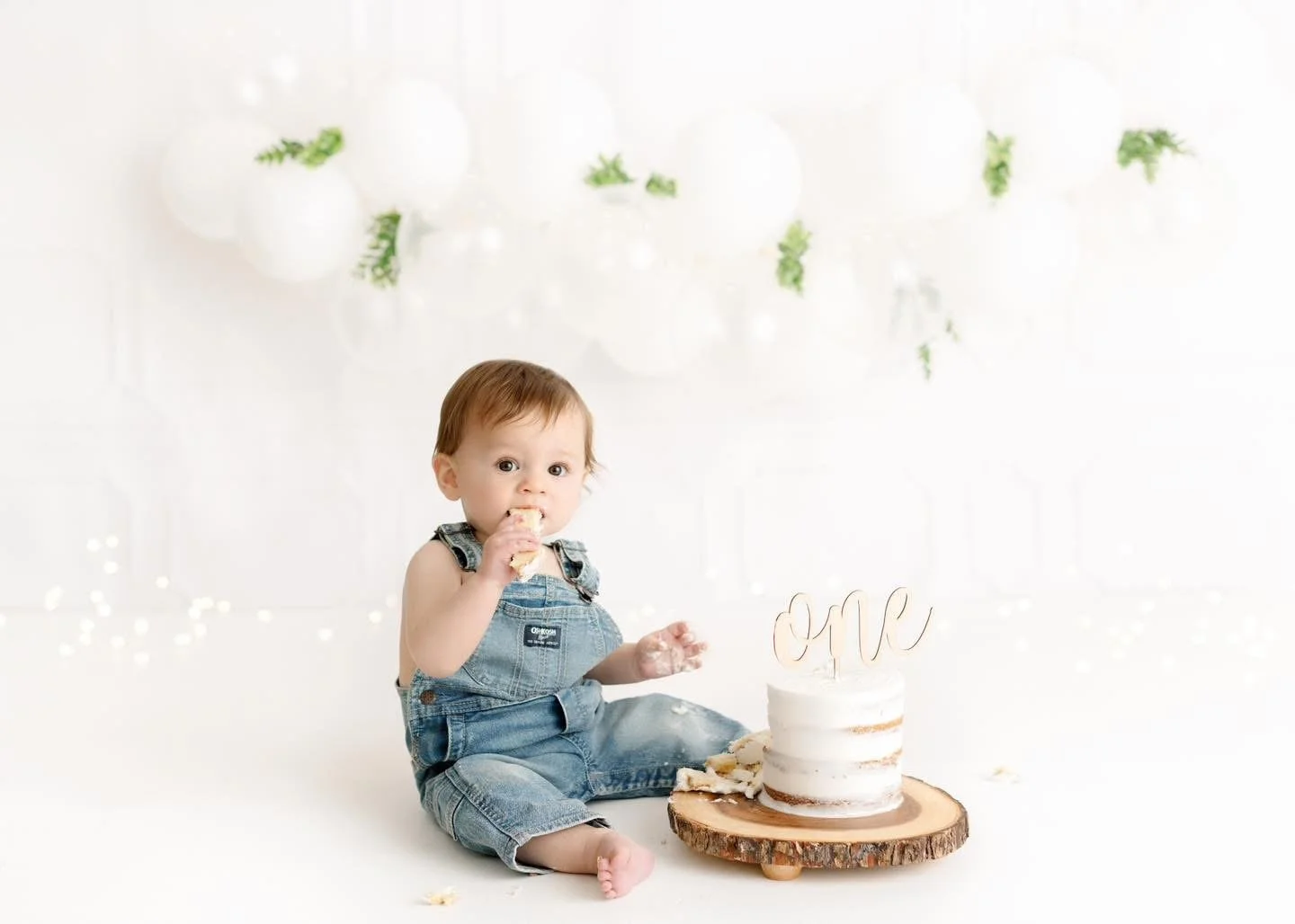 One-year-old with a styled cake at a Syracuse cake smash session
