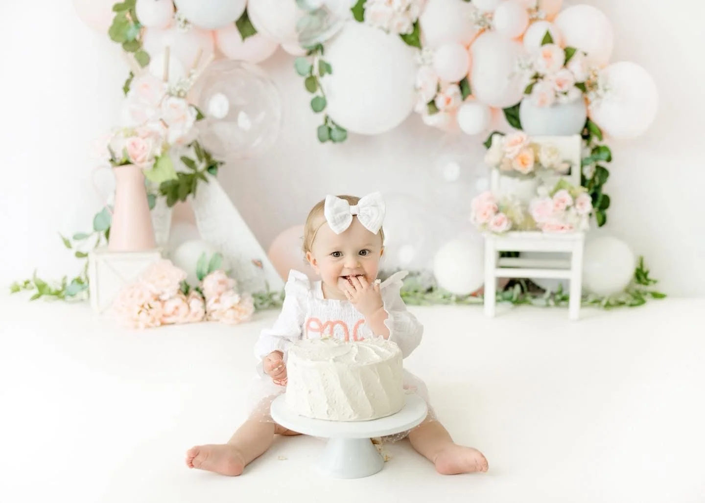 One-year-old with a styled cake at a Syracuse cake smash session