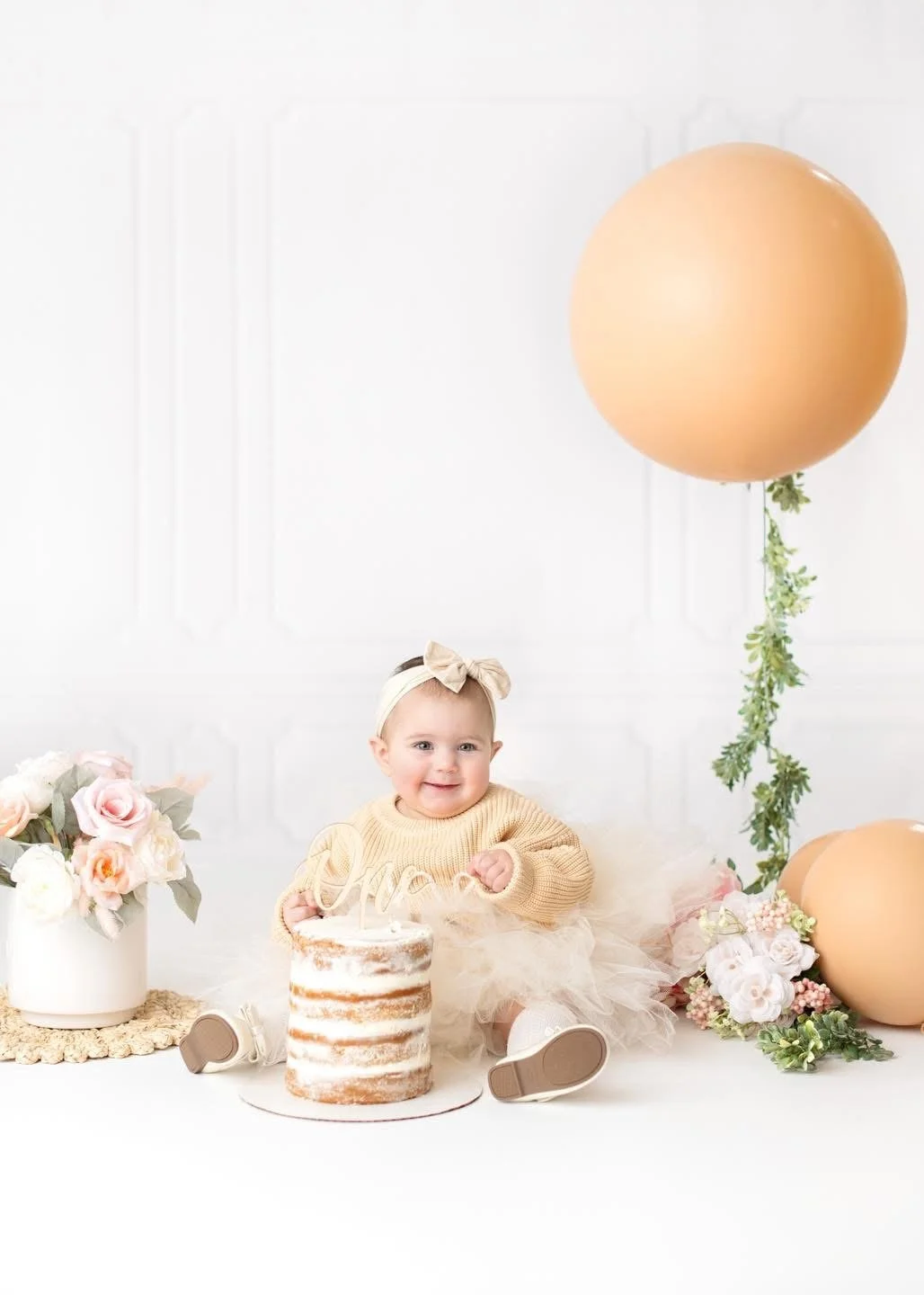 One-year-old with a styled cake at a Syracuse cake smash session