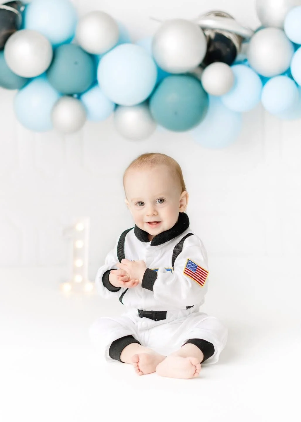 Baby exploring their first birthday cake in-studio