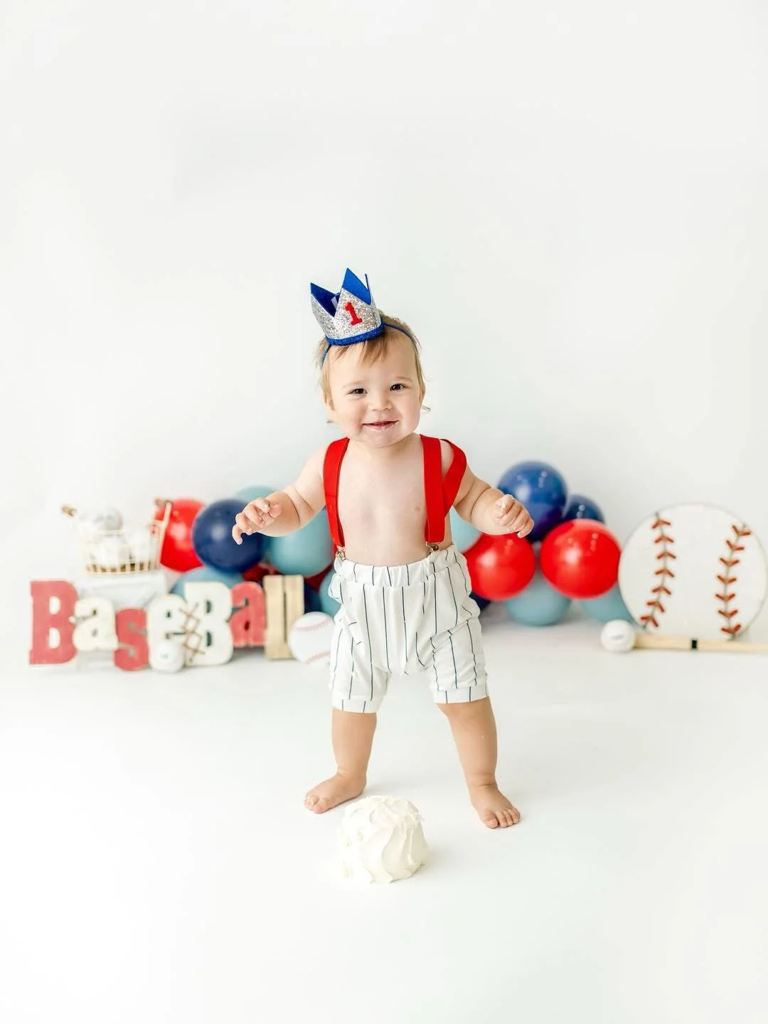 One-year-old with a styled cake at a Syracuse cake smash session