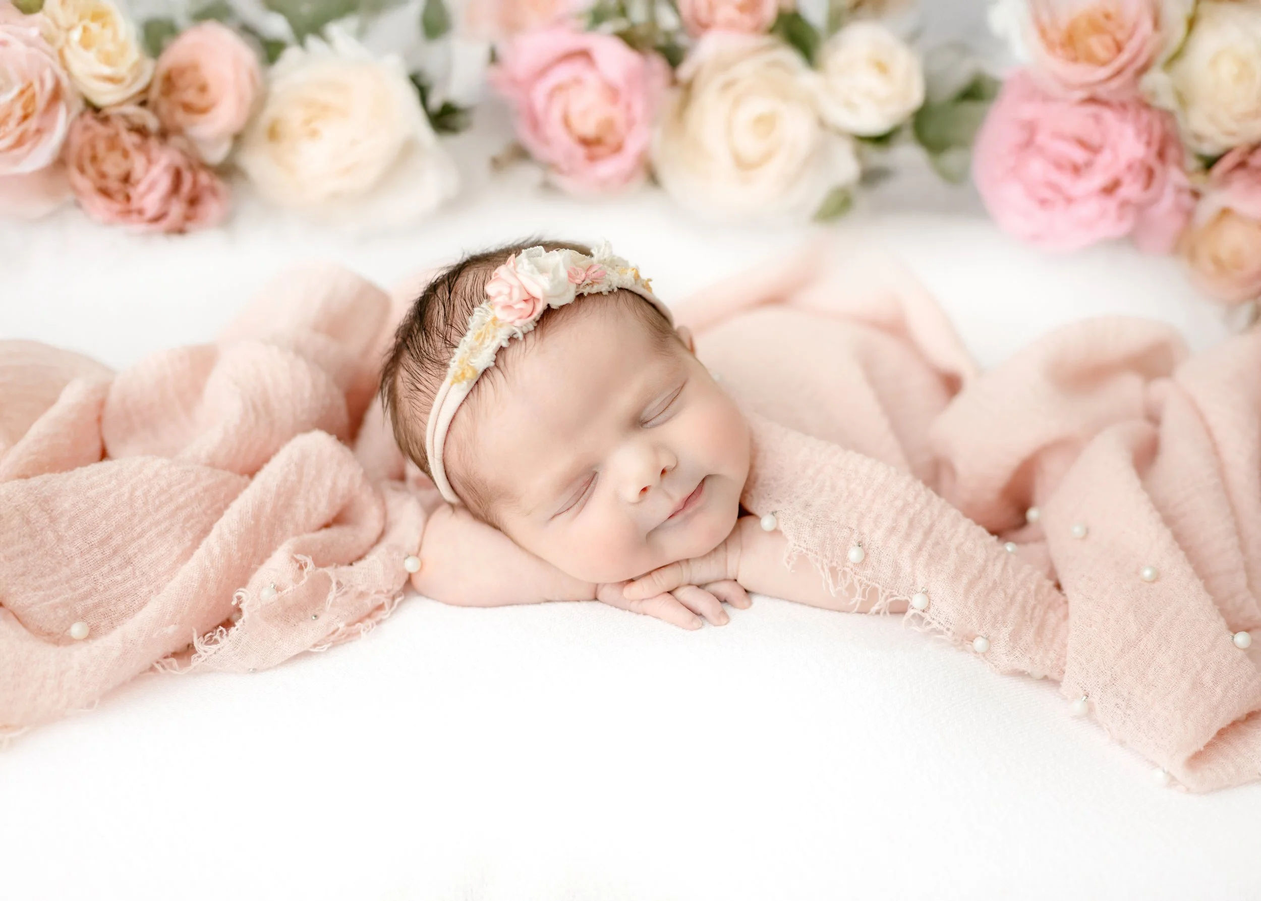 A swaddled newborn photographed in the Syracuse, NY studio