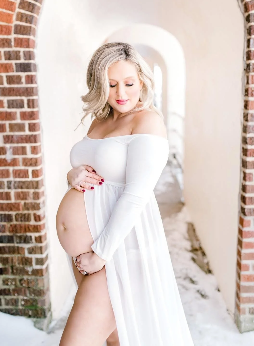 An expectant mother photographed in soft natural light in Syracuse, NY