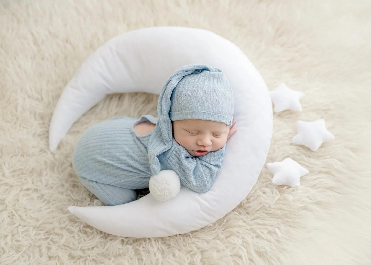 Newborn resting on a knitted blanket at a Central New York studio session