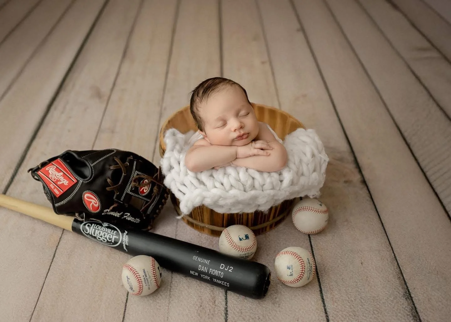 Sleeping newborn posed in a basket during a Syracuse newborn session