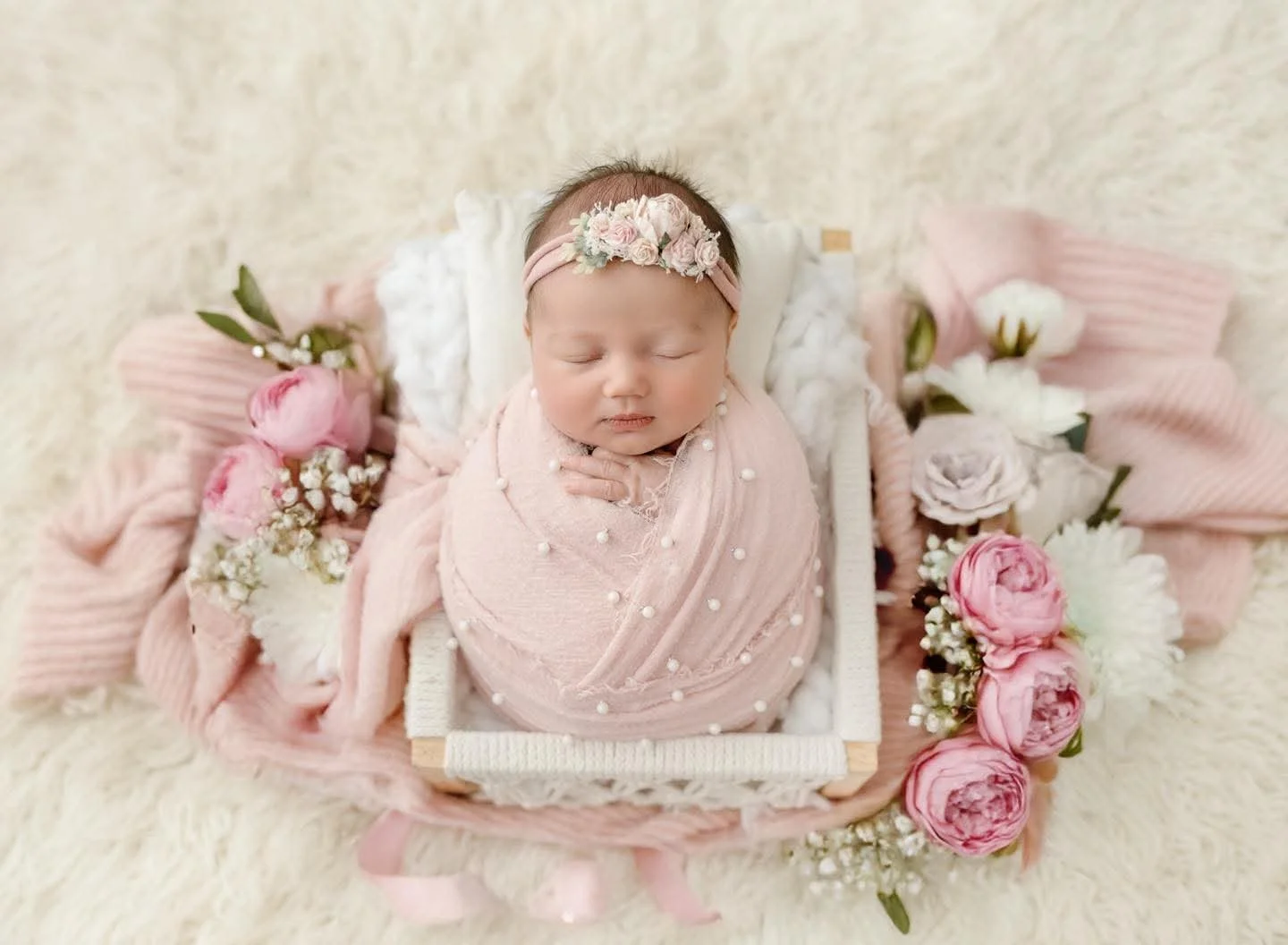 Newborn baby swaddled and sleeping in the Syracuse, NY studio