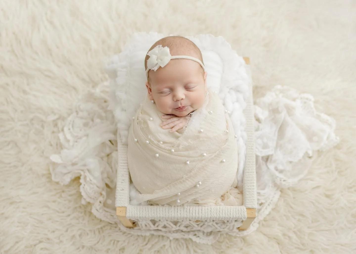 Sleeping newborn posed in a basket during a Syracuse newborn session