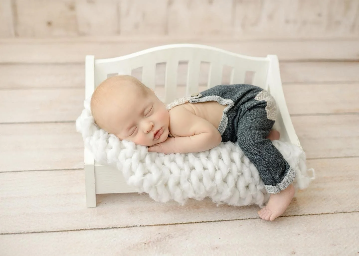 Newborn baby swaddled and sleeping in the Syracuse, NY studio